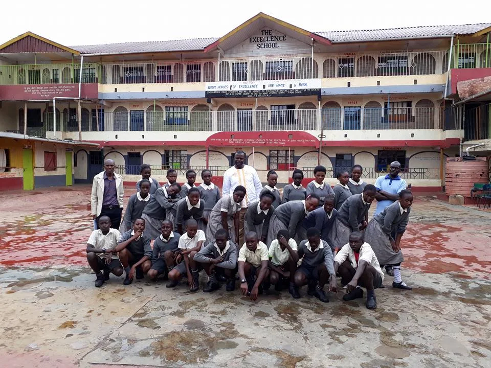 Staff and students in front of the school block